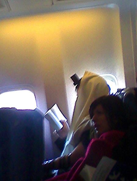 0224081126a.jpg - An unnerving sight on an transatlantic flight.  After some research, it turned out to be a legitimate Jewish prayer practice.